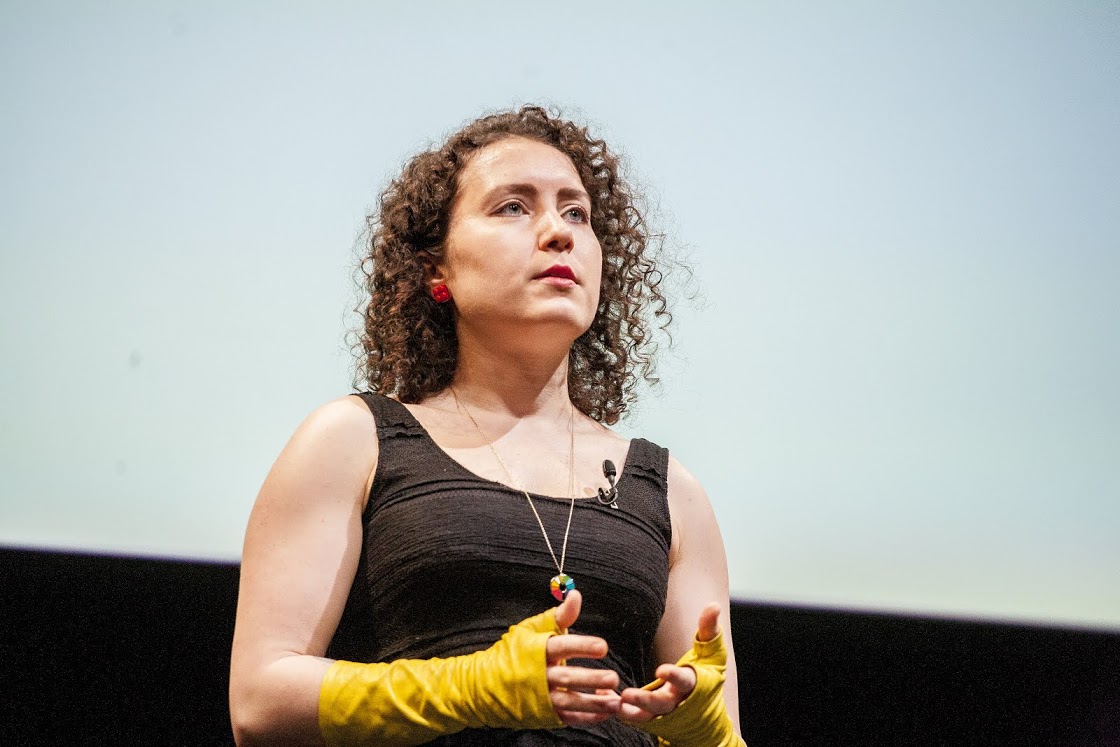 Maria Popova wearing a black top and yellow gloves